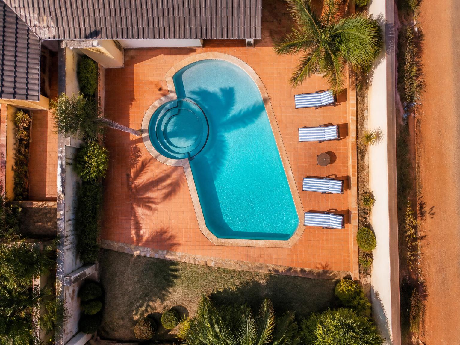 Overhead view of friends floating in a private pool